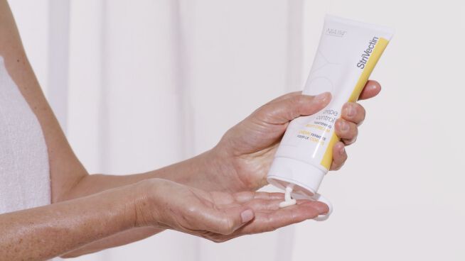 Crepe Control™ Tightening Body Cream being squeezed into hands