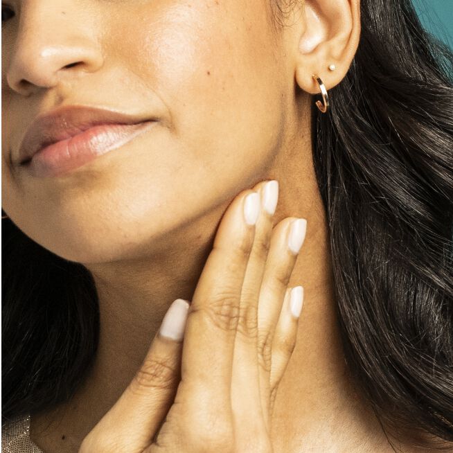 Woman smoothing in Peptight™ Tightening Neck Serum