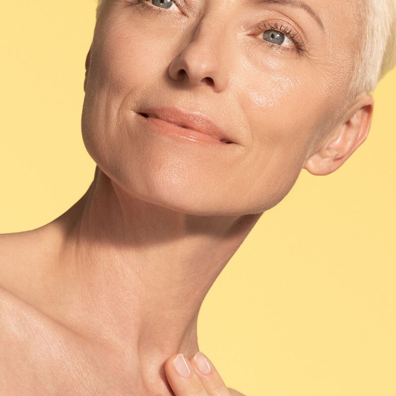 Woman after using Peptight™ Tightening Neck Serum Roller