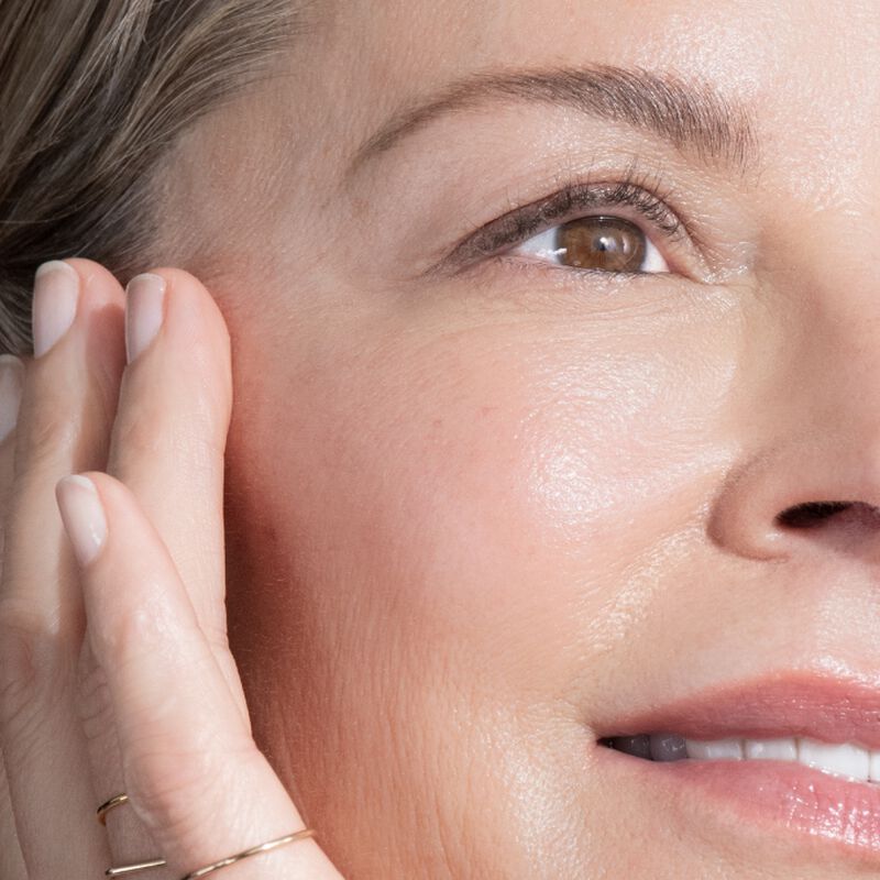 Woman massaging Advanced Retinol Multi-Correct Eye Cream into the eye area